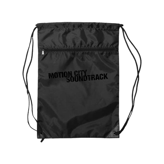 black drawstring bag with MOTION CITY SOUNDTRACK in bold black lettering, zipper pocket on the front.